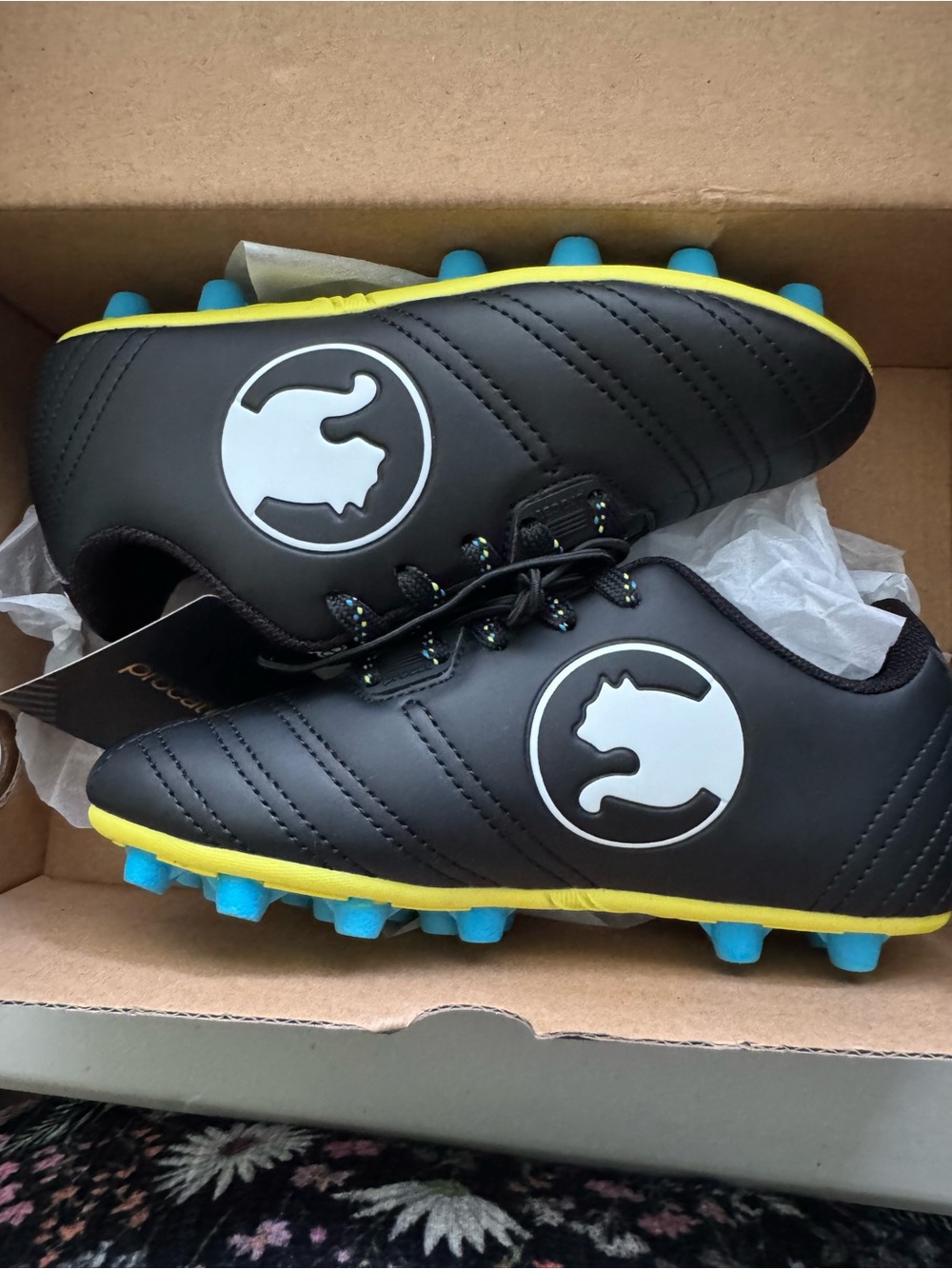 Puma Kids Black Soccer Cleats with Yellow Trim and Blue Studs